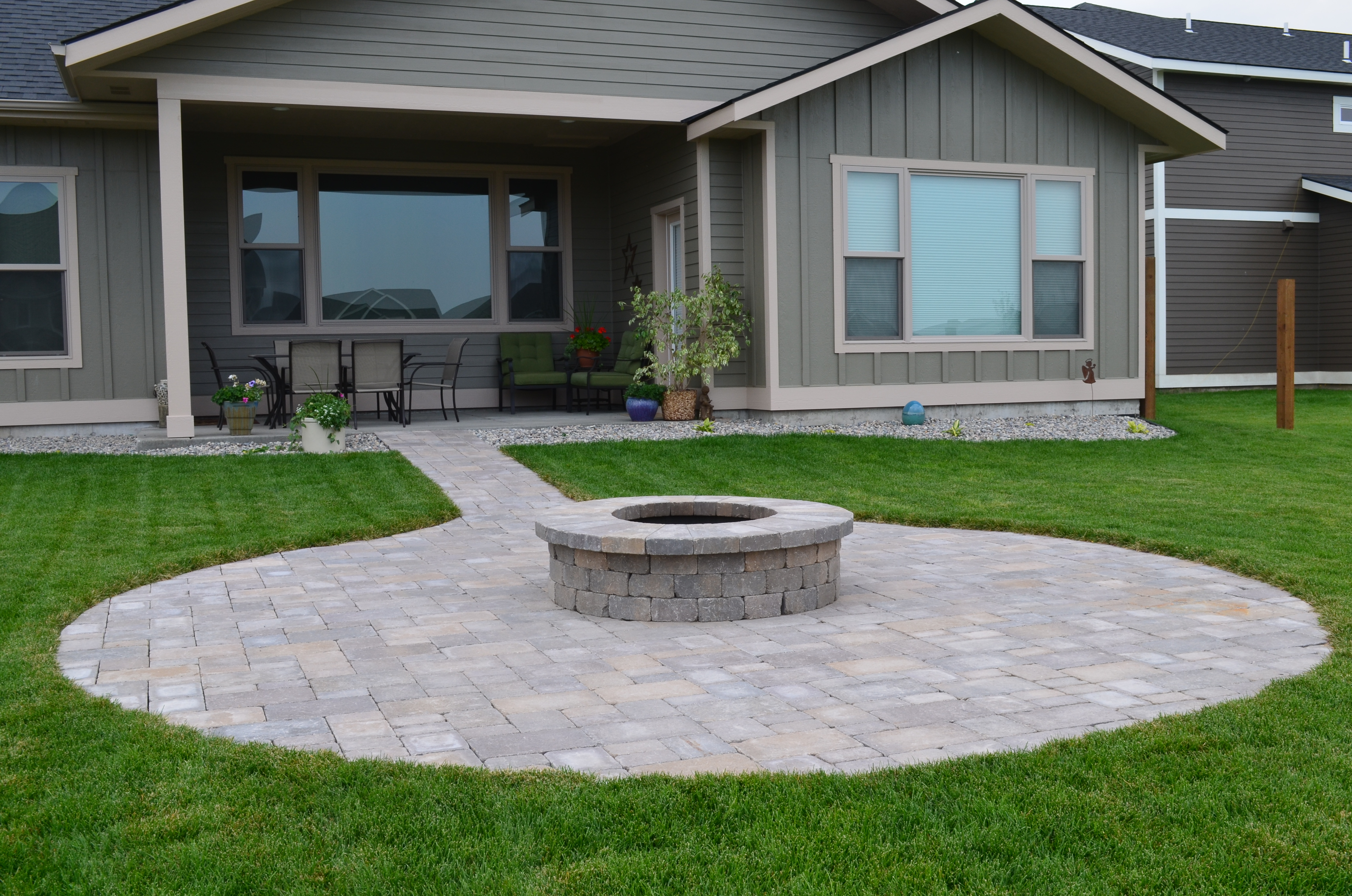 Round paver patio, fire pit, walkway. As well as full landscape installation.