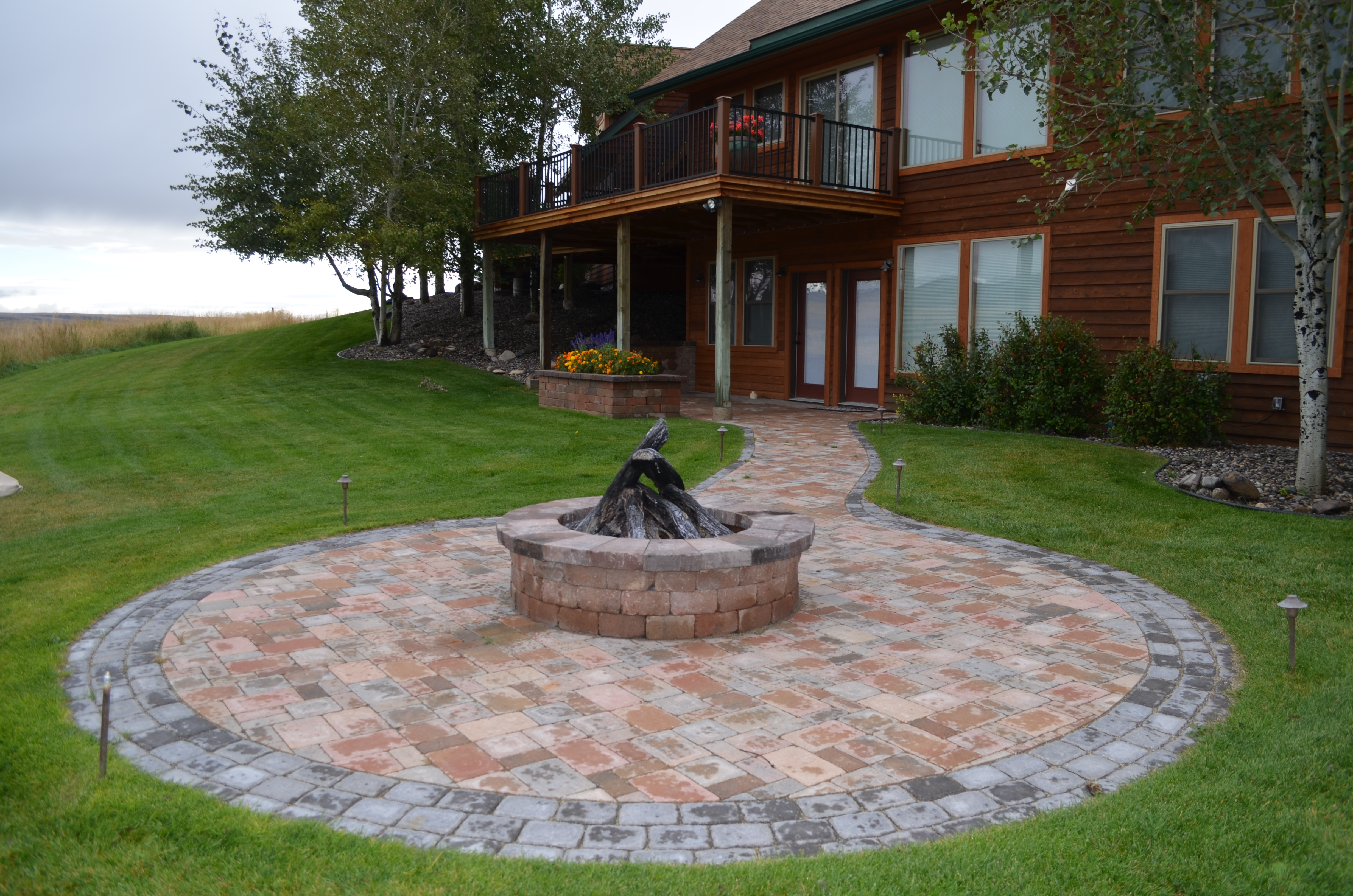 Another view of the spectacular paver patio, walkway, fire pit & landscaping.